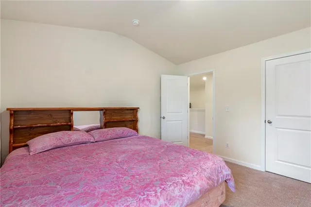 a bedroom with a bed and a night stand