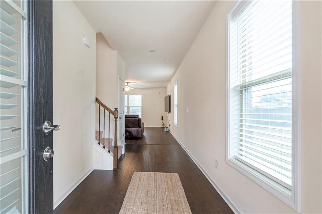 4265 Almanor Circle Norcross, GA 30071 - Photo 3 of 34 a view of a hallway with wooden floor and windows