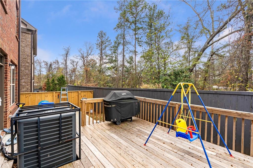 4265 Almanor Circle Norcross, GA 30071 - Photo 31 of 34 a view of a balcony with wooden floor and outdoor seating