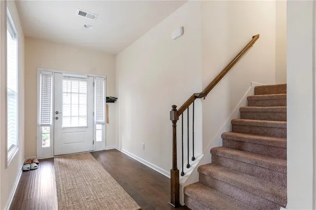 a view of entryway with wooden floor and stairs