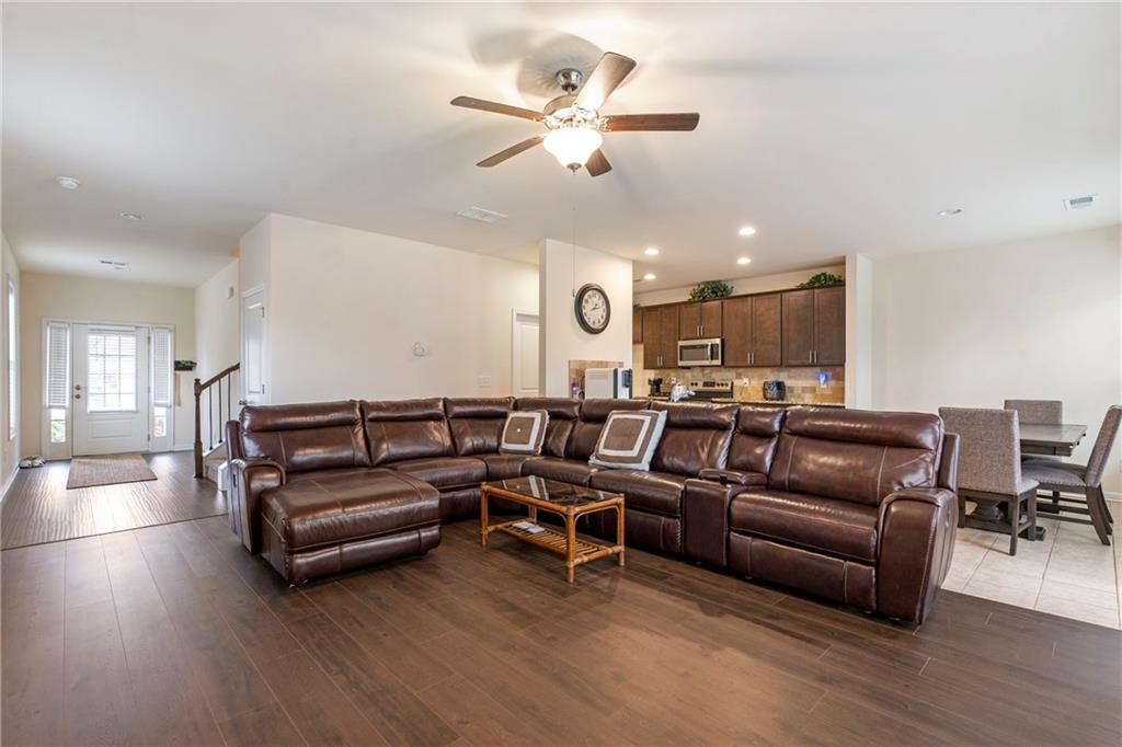 4265 Almanor Circle Norcross, GA 30071 - Photo 6 of 34 a living room with furniture kitchen view and a chandelier