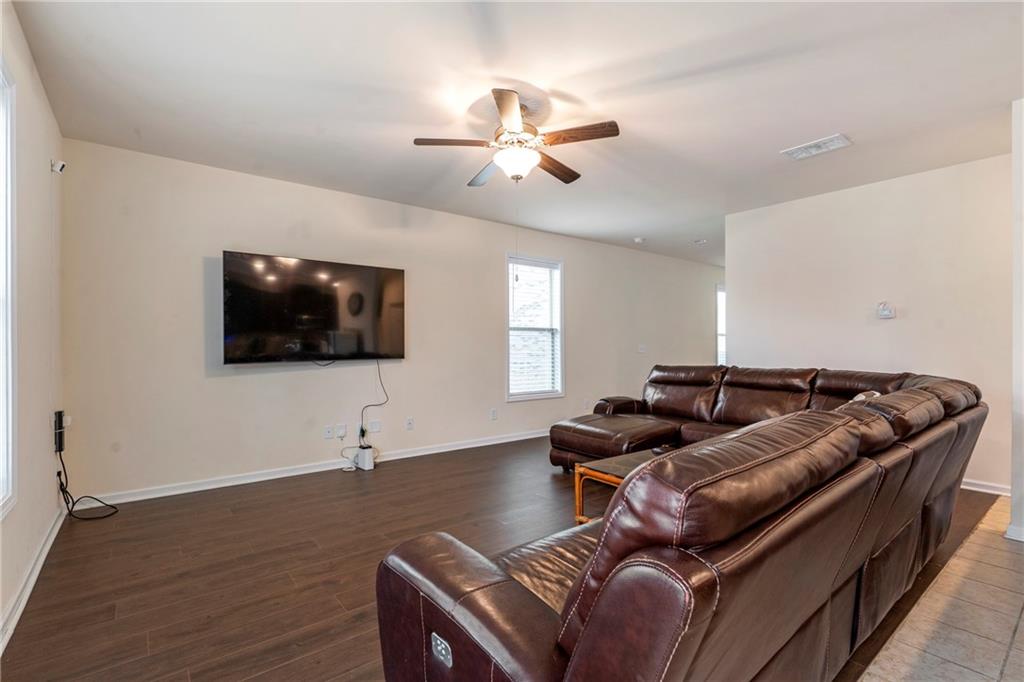 4265 Almanor Circle Norcross, GA 30071 - Photo 7 of 34 a living room with furniture and a flat screen tv
