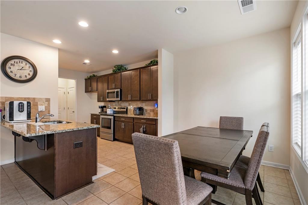 4265 Almanor Circle Norcross, GA 30071 - Photo 8 of 34 a view of kitchen with cabinets table and chairs