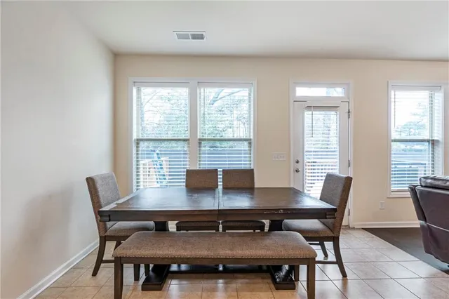 a view of a dining room with furniture and window