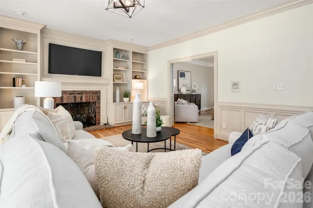 a living room with furniture a fireplace and a flat screen tv