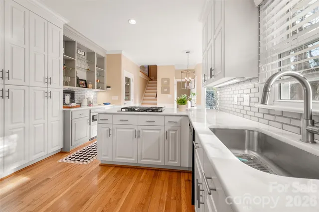 a kitchen with a sink stove and cabinets
