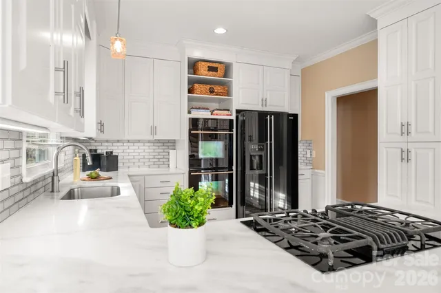 a kitchen with a refrigerator and a sink