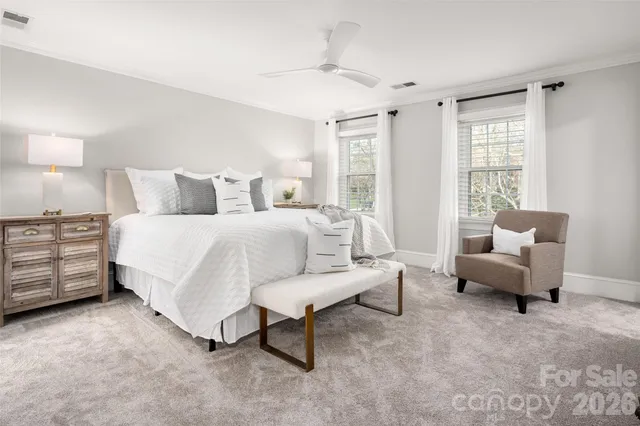 a spacious bedroom with a bed and a couch