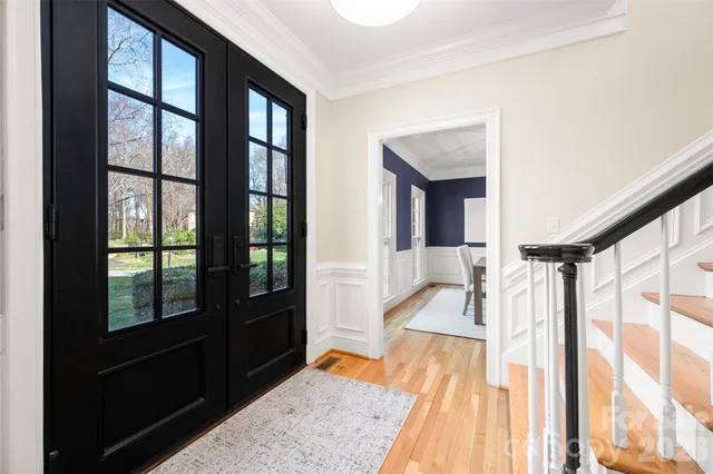 a very nice looking room with a large window and wooden floor