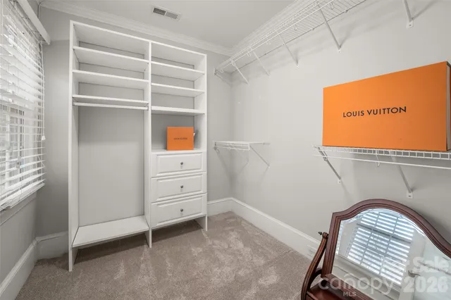 a view of room with window and a ceiling fan