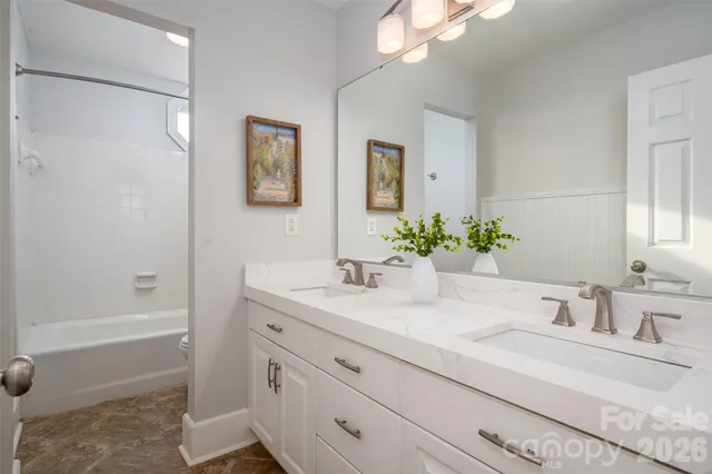 a bathroom with a tub sink and mirror