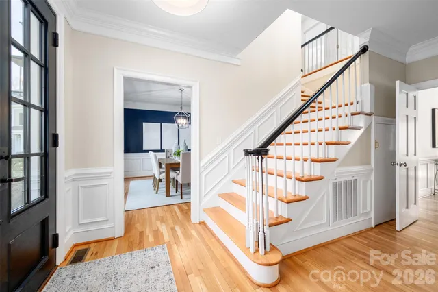 a view of entryway with wooden floor and stairs