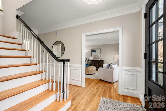 a view of a hallway with wooden floor and entryway