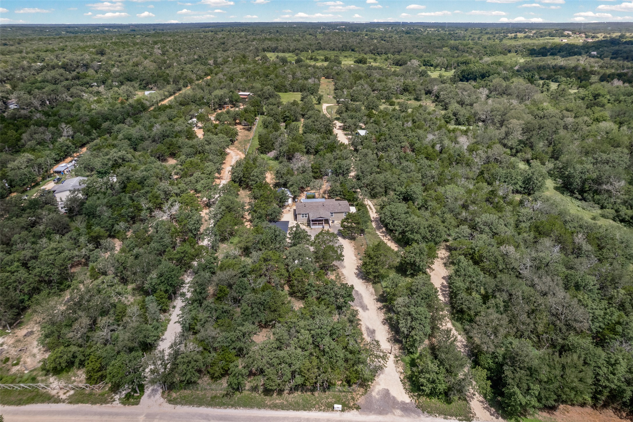 564 Boyd Road Red Rock, TX 78662 - Photo 7 of 25 An aerial perspective showcases a secluded home nestled amongst dense, verdant woodlands.
