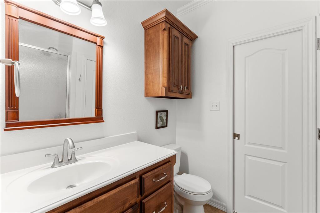 345 Rains County Road 3390 Emory, TX 75440 - Photo 33 of 39 a bathroom with a sink a toilet and a mirror