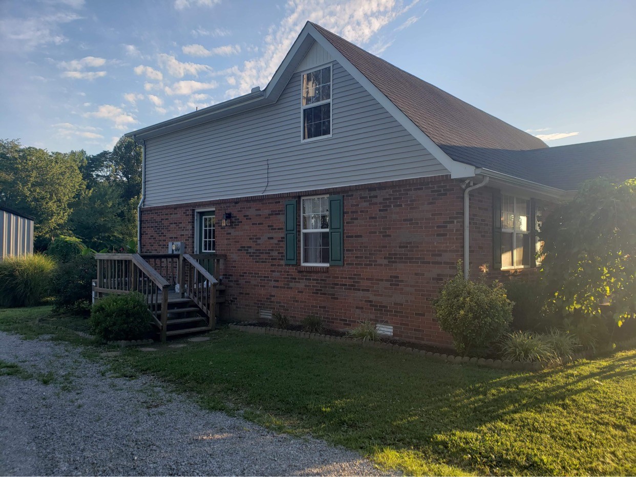 714 Days Road Lafayette, TN 37083 - Photo 3 of 19 a view of a house with backyard and garden