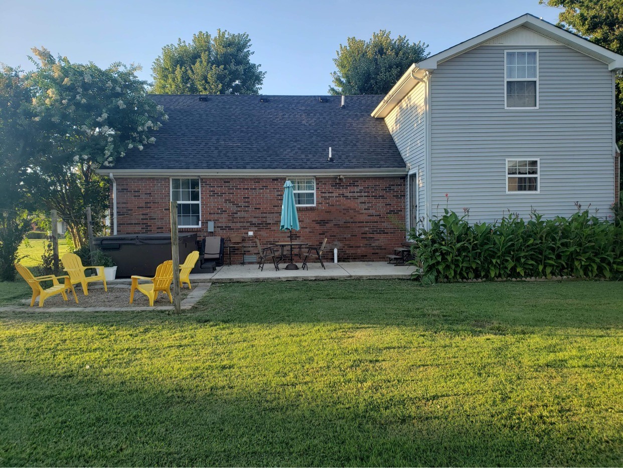 714 Days Road Lafayette, TN 37083 - Photo 4 of 19 a view of a house with backyard sitting area and garden