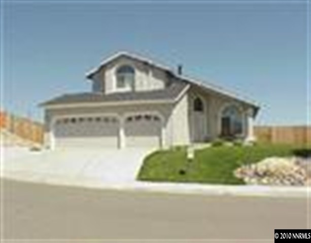14465 Ghost Rider Drive Reno, NV 89511 - Photo 1 of 1 a front view of a house with a yard