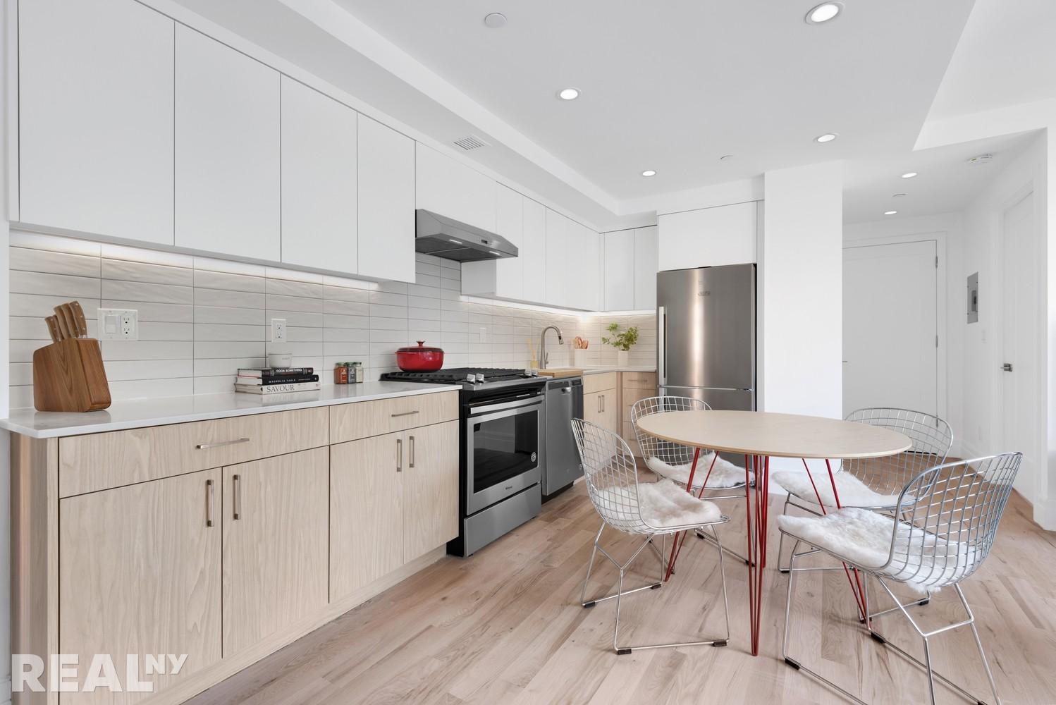 77 Clarkson Avenue, Unit 1D Brooklyn, NY 11226 - Photo 3 of 13 a kitchen with stainless steel appliances a stove a sink dishwasher a refrigerator and white cabinets with wooden floor