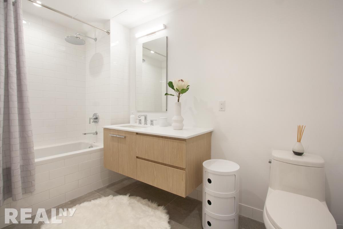 77 Clarkson Avenue, Unit 1D Brooklyn, NY 11226 - Photo 5 of 13 a bathroom with a sink a toilet and shower