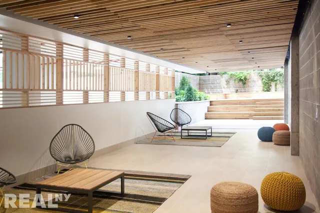 a hallway with a bench and painted walls