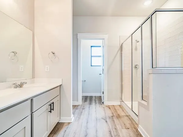 a spacious bathroom with a double vanity sink and a mirror