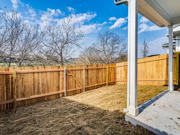 a view of a backyard of the house