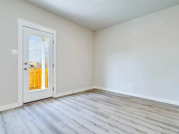 a view of a kitchen with a sink and a refrigerator