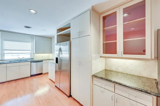 a kitchen with a refrigerator and a sink