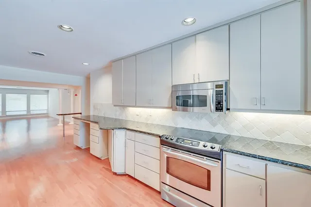 a kitchen with a sink stove and cabinets