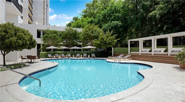a view of a swimming pool with chairs