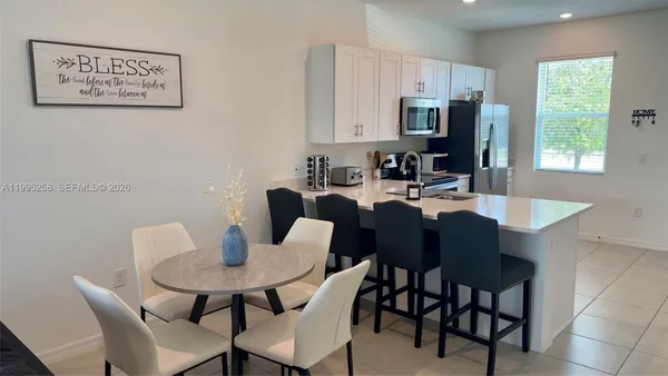 a view of a dining room with furniture and window