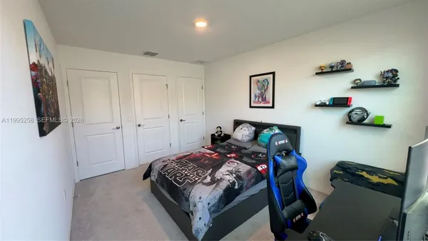 a bedroom with a bed a wall and closet