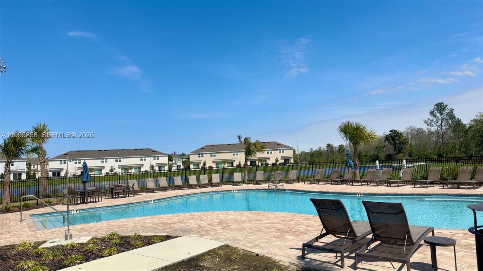3381 Composition Street Kissimmee, FL 34758 - Photo 15 of 16 a view of swimming pool with outdoor seating and city view