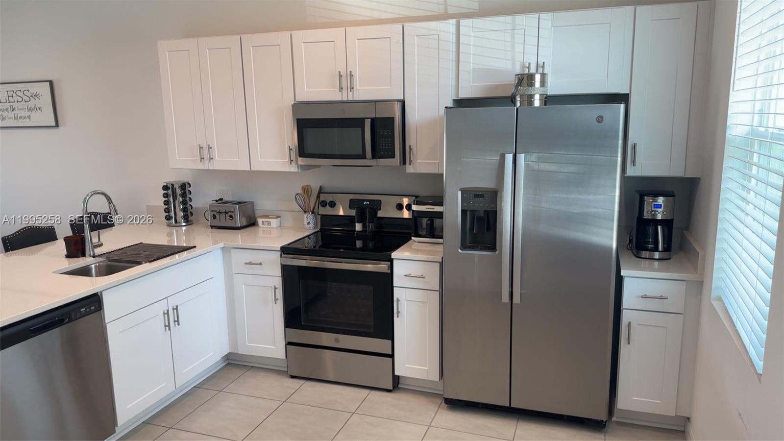 3381 Composition Street Kissimmee, FL 34758 - Photo 2 of 16 a kitchen with cabinets and stainless steel appliances