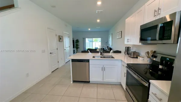 a kitchen with stainless steel appliances a sink stove and microwave