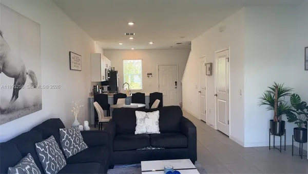 a living room with furniture and a potted plant