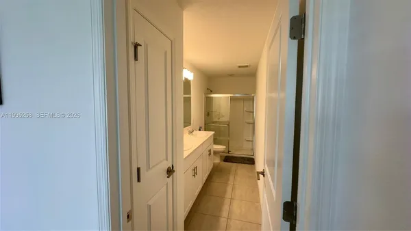 a bathroom with a glass shower door