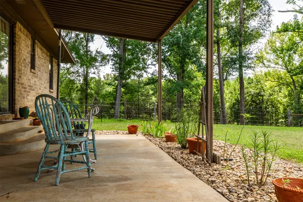 a view of a patio with a table chairs and a backyard