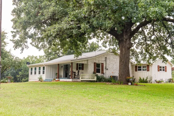 a front view of house with yard and green space