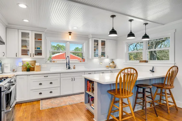 a kitchen with stainless steel appliances granite countertop a white cabinets and a dishwasher