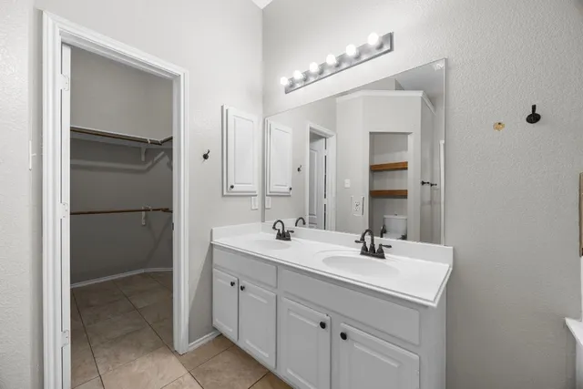 a bathroom with a double vanity sink mirror and