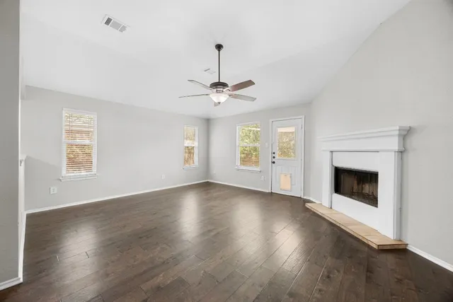 a view of livingroom with fireplace wooden floor and window