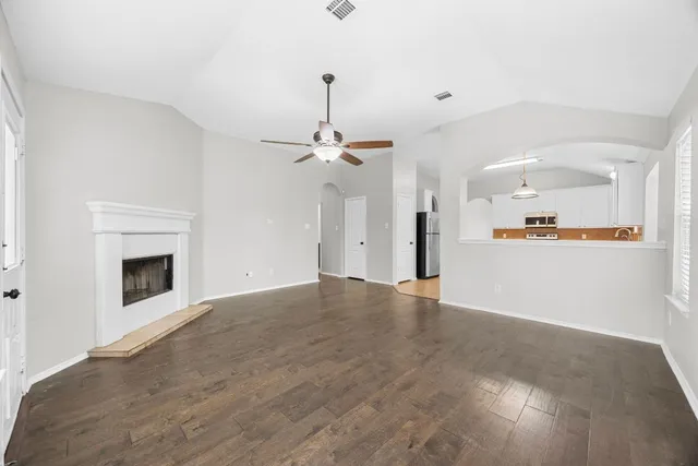a view of a kitchen with a sink and a fireplace