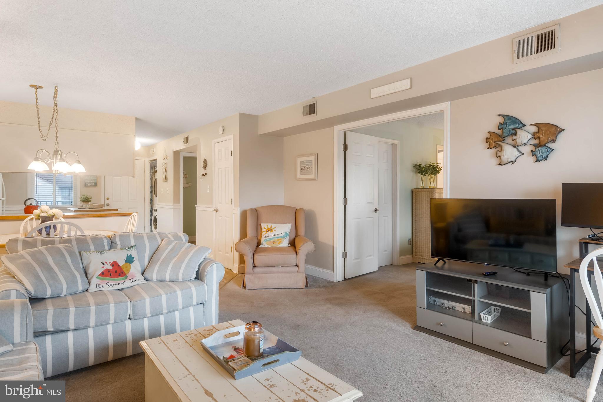 9203 Rusty Anchor Road, Unit A3 Ocean City, MD 21842 - Photo 13 of 40 a living room with furniture and a flat screen tv