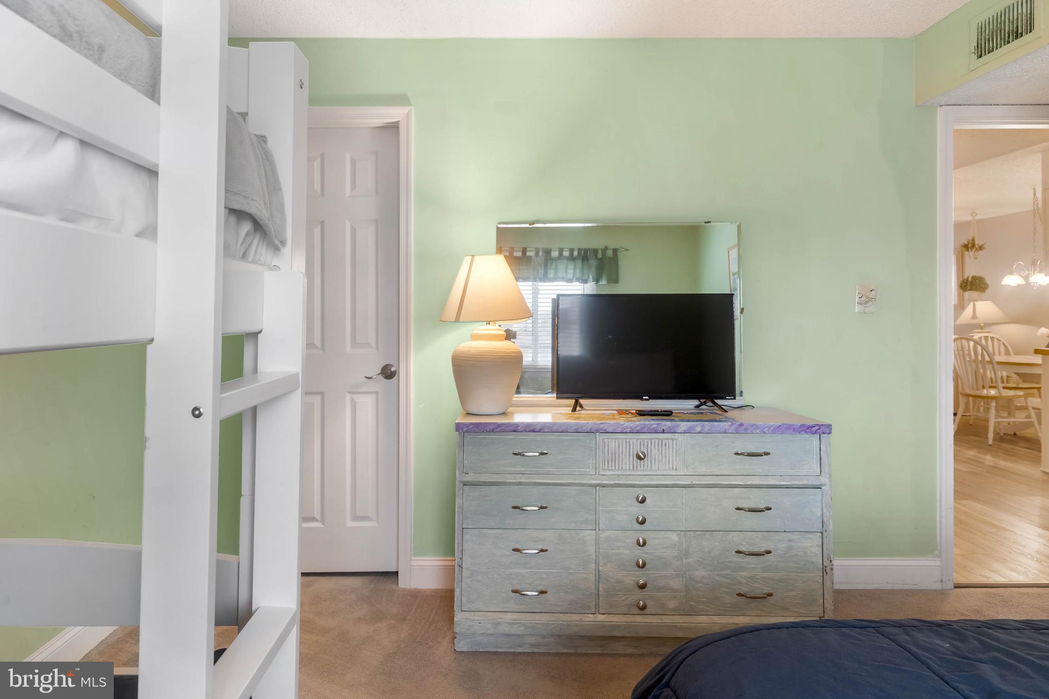 9203 Rusty Anchor Road, Unit A3 Ocean City, MD 21842 - Photo 18 of 40 a living room with furniture and flat screen tv