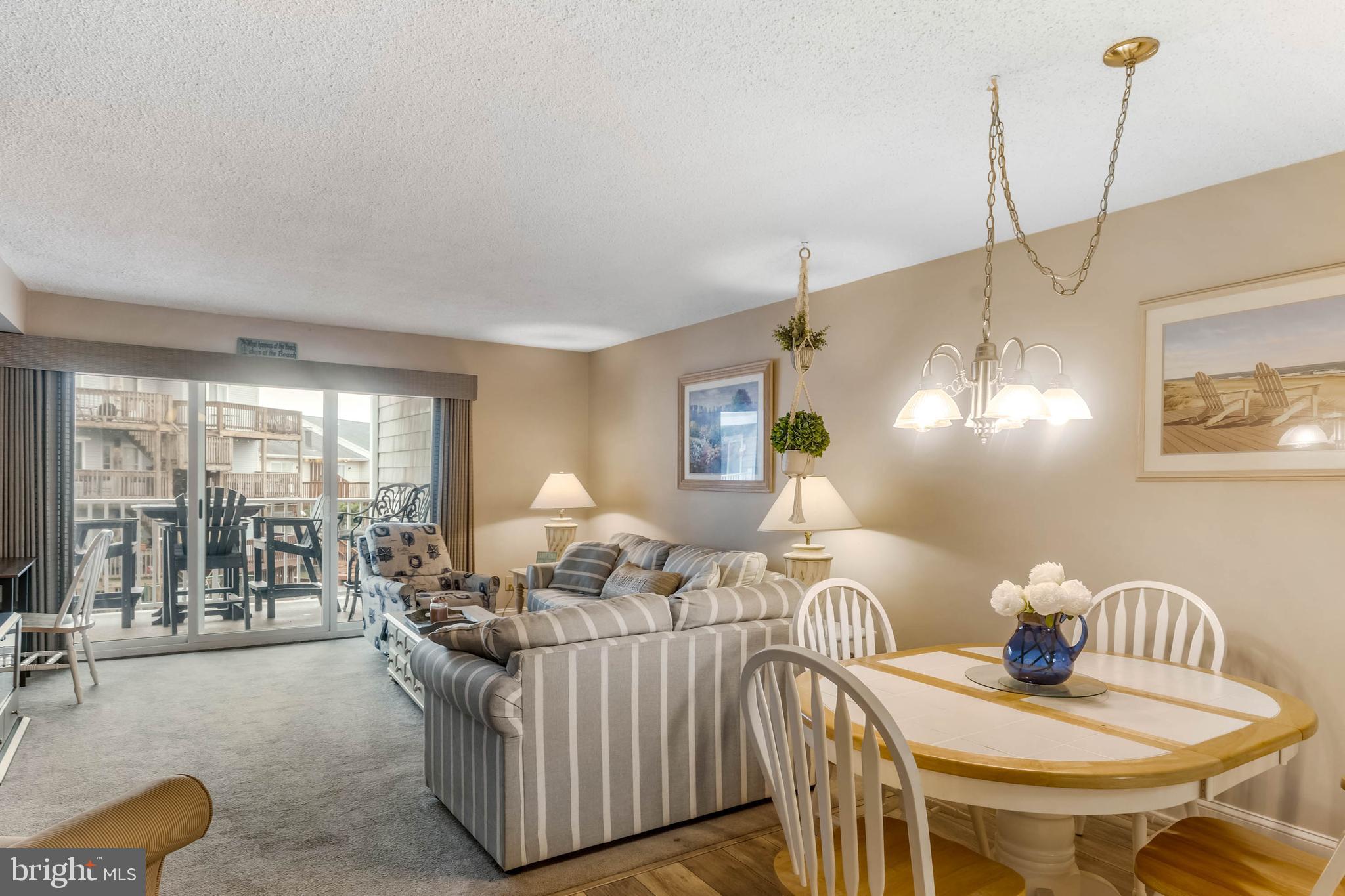 9203 Rusty Anchor Road, Unit A3 Ocean City, MD 21842 - Photo 8 of 40 a living room with furniture and a large window
