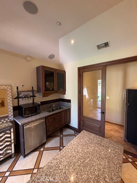 44 Hackamore Lane, Unit 46 Bell Canyon, CA 91307 - Photo 10 of 26 a kitchen with stainless steel appliances kitchen island granite countertop a sink and a stove top oven