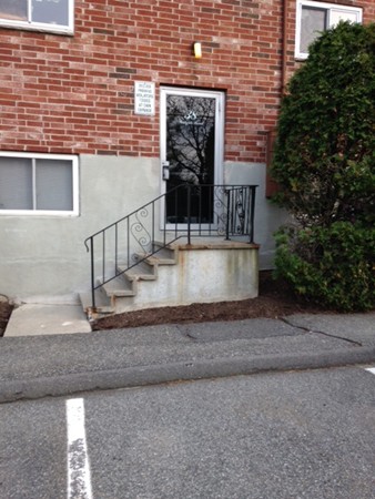 38 Westgate Road, Unit 5 Boston, MA 02467 - Photo 2 of 10 a view of a brick house with a small entryway