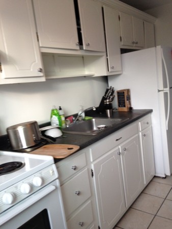 38 Westgate Road, Unit 5 Boston, MA 02467 - Photo 4 of 10 a kitchen with appliances cabinets and a counter top